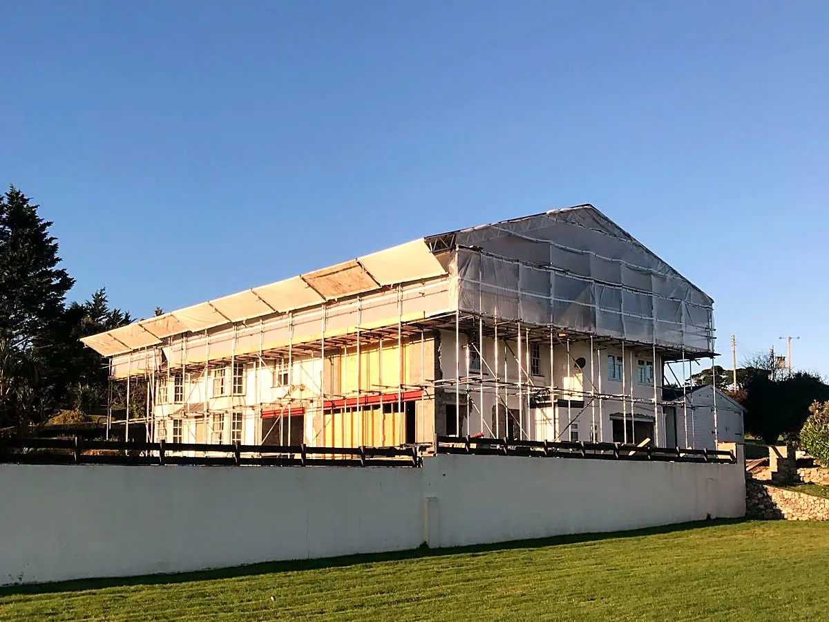 Temporary roof and full scaffold wrap on a large property