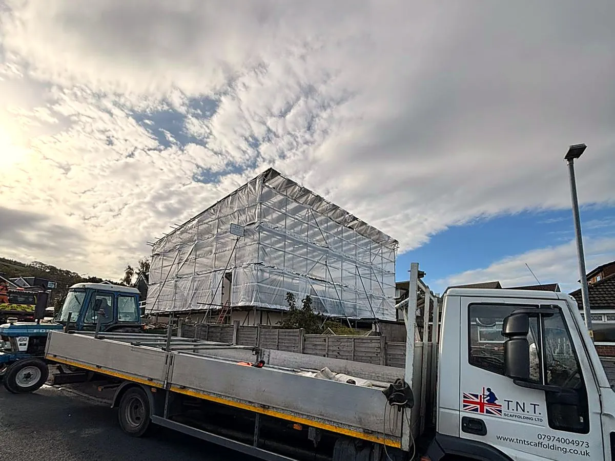 TNT wagon in front of a scaffold-supported temporary roof